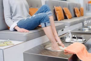 woman sitting and getting a pedicure