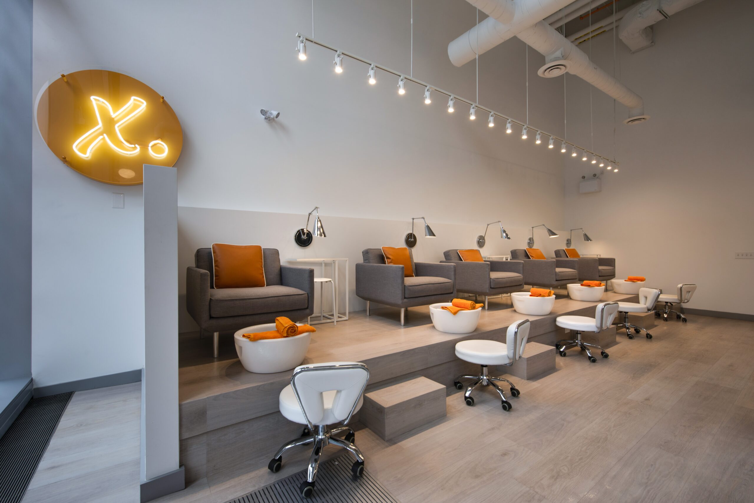 pedicure seats with orange pillows
